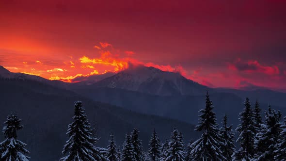 Time Lapse Red Sunset over Winter Mountain Valley