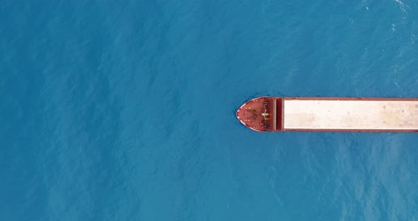 Freight Ship Floating on Sea. Aerial View alt