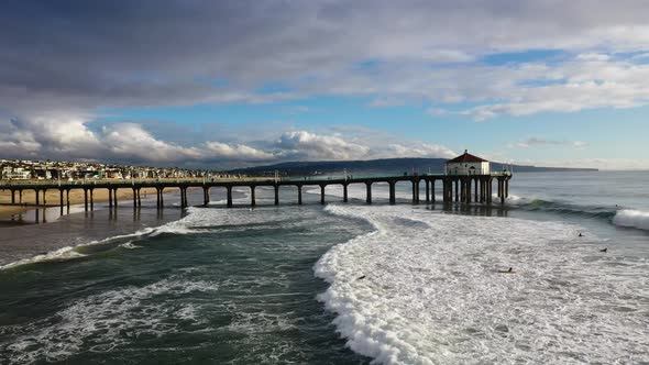 People swimming in the ocean wave. Aerial drone view of coastal Manhattan Beach, California. alt