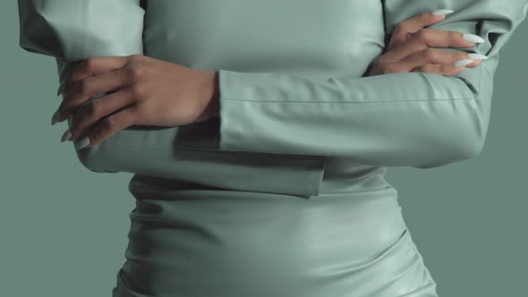 Mixed Race Woman with Big Curly Hair in Leather Fashion Dress in Studio