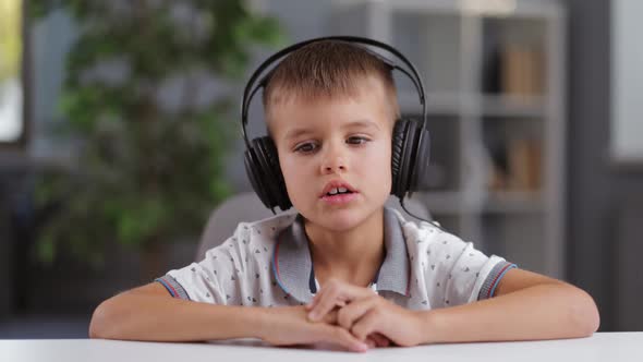 Boy in Headphones Talking on Camera