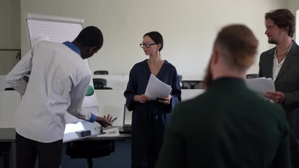 Group of Caucasian Business People Listening African American Expert Talking Pointing at alt
