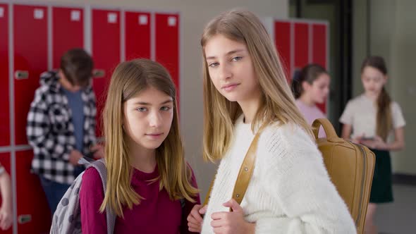 Video portrait of schoolgirls standing in school corridor. Shot with RED helium camera in 8K. alt