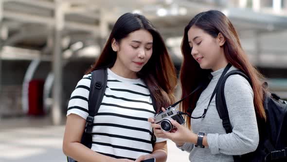 Travellers backpacker teenager female using camera shooting beautiful place alt