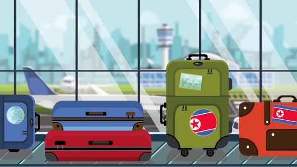 Suitcases with North Korea Flag Stickers on Baggage in Airport alt