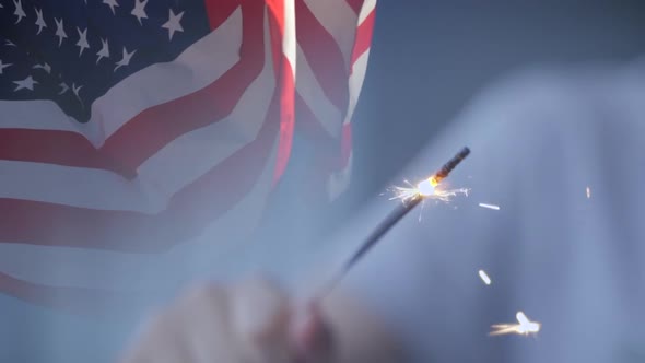 USA Flag Waving and Kid Playing with a Sparkler in Slow Motion alt