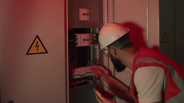 Electrical Technician Working During Accidental Situation at the Factory alt