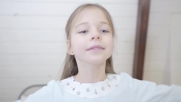 Camera Following Little Caucasian Girl Falling Back on Soft Bed. Cheerful Brunette Child Enjoying alt