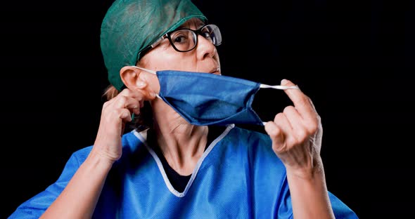 Female Doctor is Taking off her Mask.