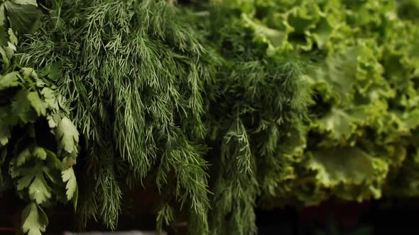 Caucasian Woman with Blond Hair in Medical Protective Mask Chooses Broccoli and Cauliflower at