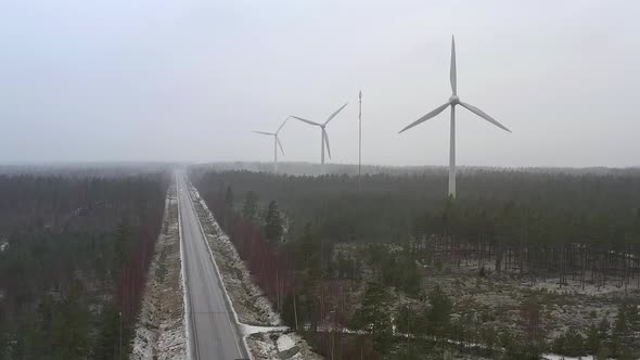 Amazing Drone Shot of Wind Generators Next to a Road in Finland
