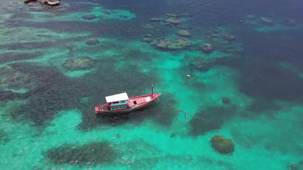 Boats Anchoring in Turquoise Shallow Water By the Edge of Coral Reef alt