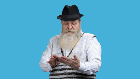 Old Surprised Man Using Transparent Plastic Device alt