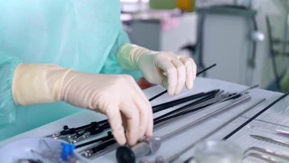 Surgeon's Assistant Prepares Tools for Surgery
