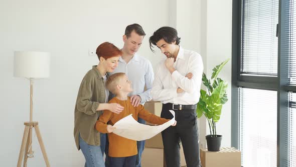Family And Real Estate Agent Communicating While Examining Blueprints alt