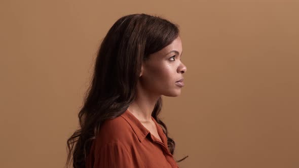 A side view of a brunette african american woman looking to the top alt