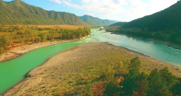 Low Altitude Flight Over Fresh Fast Mountain River with Rocks at Sunny Summer Morning. alt