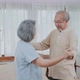 Asian happy Senior elderly Couple stay at home, spending leisure time in living room together.