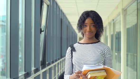 African American Woman Student with a Books in the University. New Modern Fully Functional Education alt