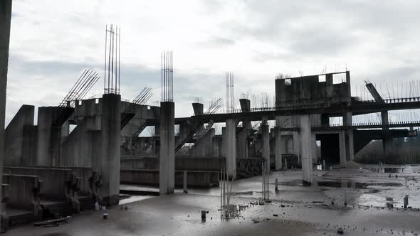 Concrete columns, girders and beams reinforced with steel bars on abandoned construction site alt