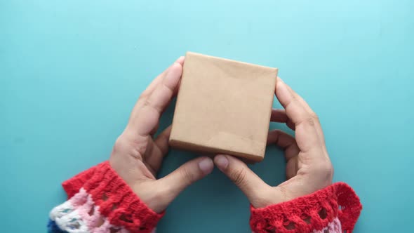 Top View of Person Open a Empty Small Gift Box alt