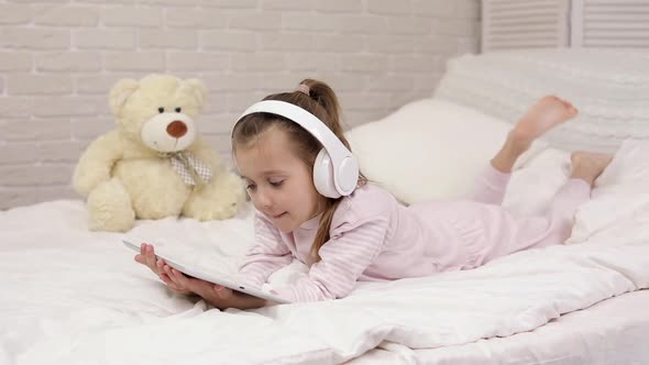 Little Child Baby Girl Listening To the Music with Headphones