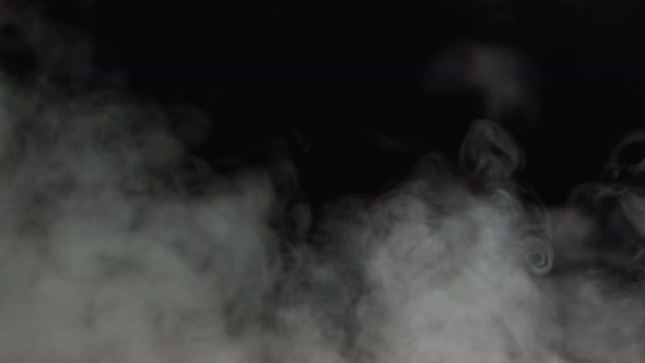 Soft Fog in Slow Motion on Dark Backdrop. Realistic Atmospheric Gray Smoke  on Black Background by volodymyrfelbaba