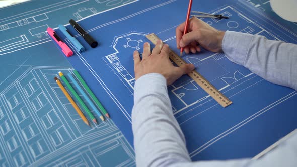 Close-up the architect draws elements of the interior of the house alt