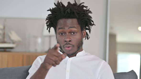 Portrait of African Man Pointing with Finger and Inviting  alt