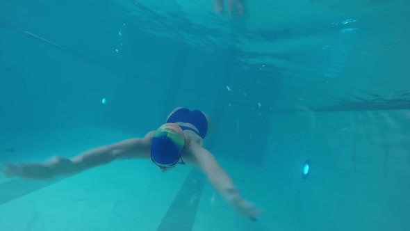 Female Athlete Swimming Underwater alt