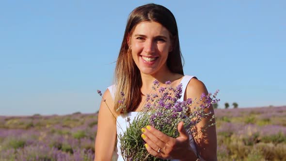 Happy Smiling Woman Holds a Bouquet of Lavender