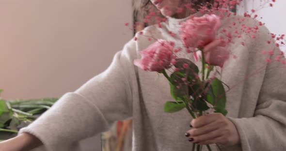 Florist woman making bouquet in flower shop, closeup hands. Floral business concept. alt