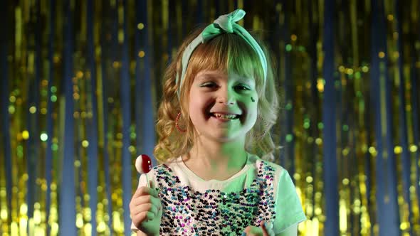 Stylish Child Girl with Lollipop Candy Looking at Camera Smiling Screaming Shouting at Disco Club alt
