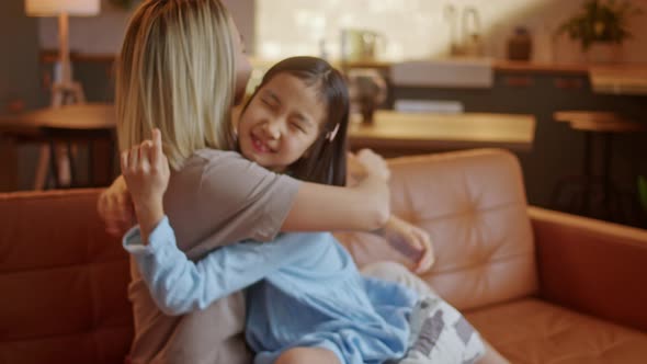 Portrait of a Mother Lovingly Embracing Her Daughter alt