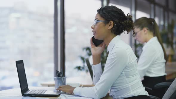 Smiling Cheerful Female Worker Talking on Smartphone With Client, Teamwork alt