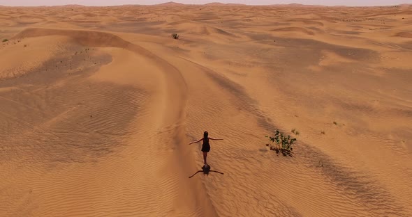 Girl Walks in the Desert