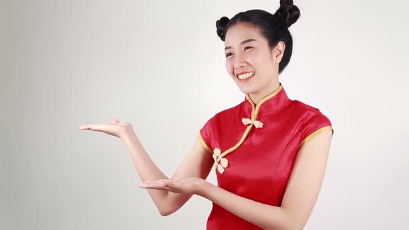 woman wear red cheongsam with open hand palm in concept of happy chinese new year alt