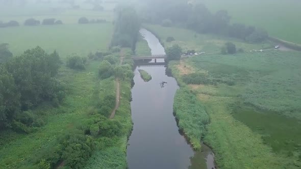 Aerial amazing view of the ecosystem at the River Otter in Devon, England, Drone gains height and fl alt