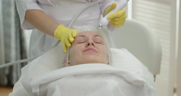 The Doctor Performs Cosmetic Procedures In A Beauty Salon On The Face Of A Young Woman alt