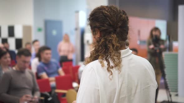 Female Speaker Giving Speech at Lecture alt
