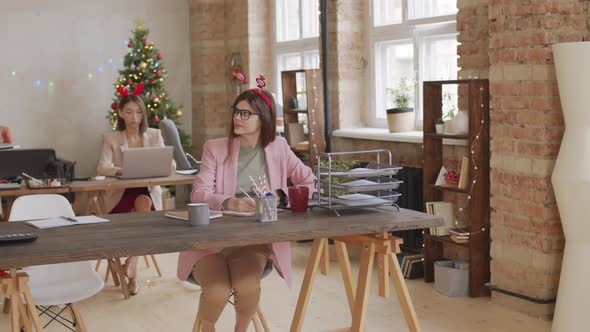 Businesspeople Working in Office on Christmas alt