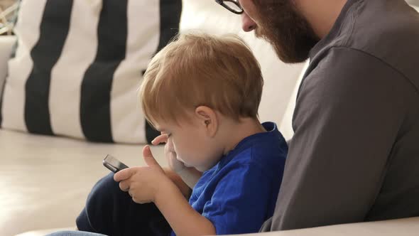 Father and Son using digital tablet together