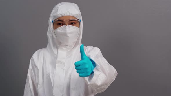doctor in protective PPE suit doing thump up hand sign