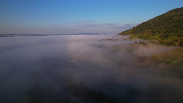 4K Aerial view of the misty sunrise in the forest. Tropical Rainforest in Thailand alt