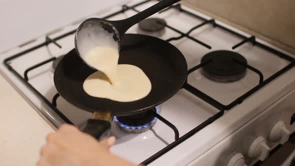 Pouring Pancake Mixture on a Frying Pan Closeup