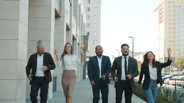Diverse Group of Businesspeople Dancing Walking Outdoors in Modern City alt