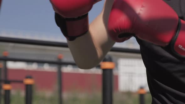 Furious Man Boxing Punch Bag Outdoors alt