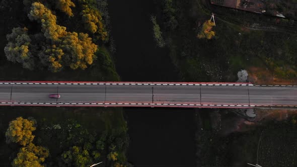 Red Car Drives Across the River