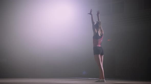 Junior Female Gymnast at Competition Teen Girl is Preparing to Perform Floor Exercise Rear View alt