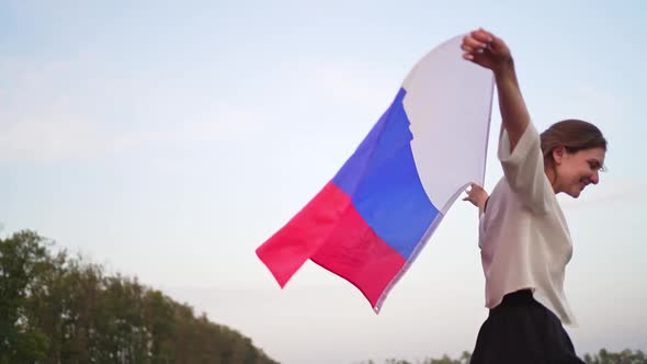 The Symbol of Russia - Flag in the Hands of a Woman. Independence and Patriotism